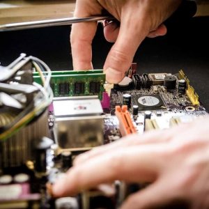 computer circuit board being fixed by hands