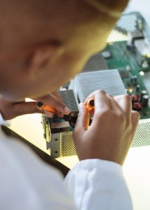 faceless-professional-repairer-fixing-video-card-in-service