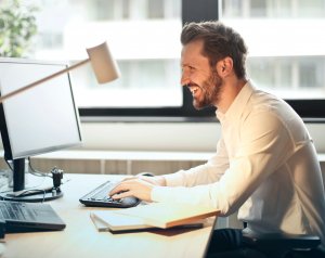 man-in-white-dress-shirt-sitting-on-black-rolling-chair