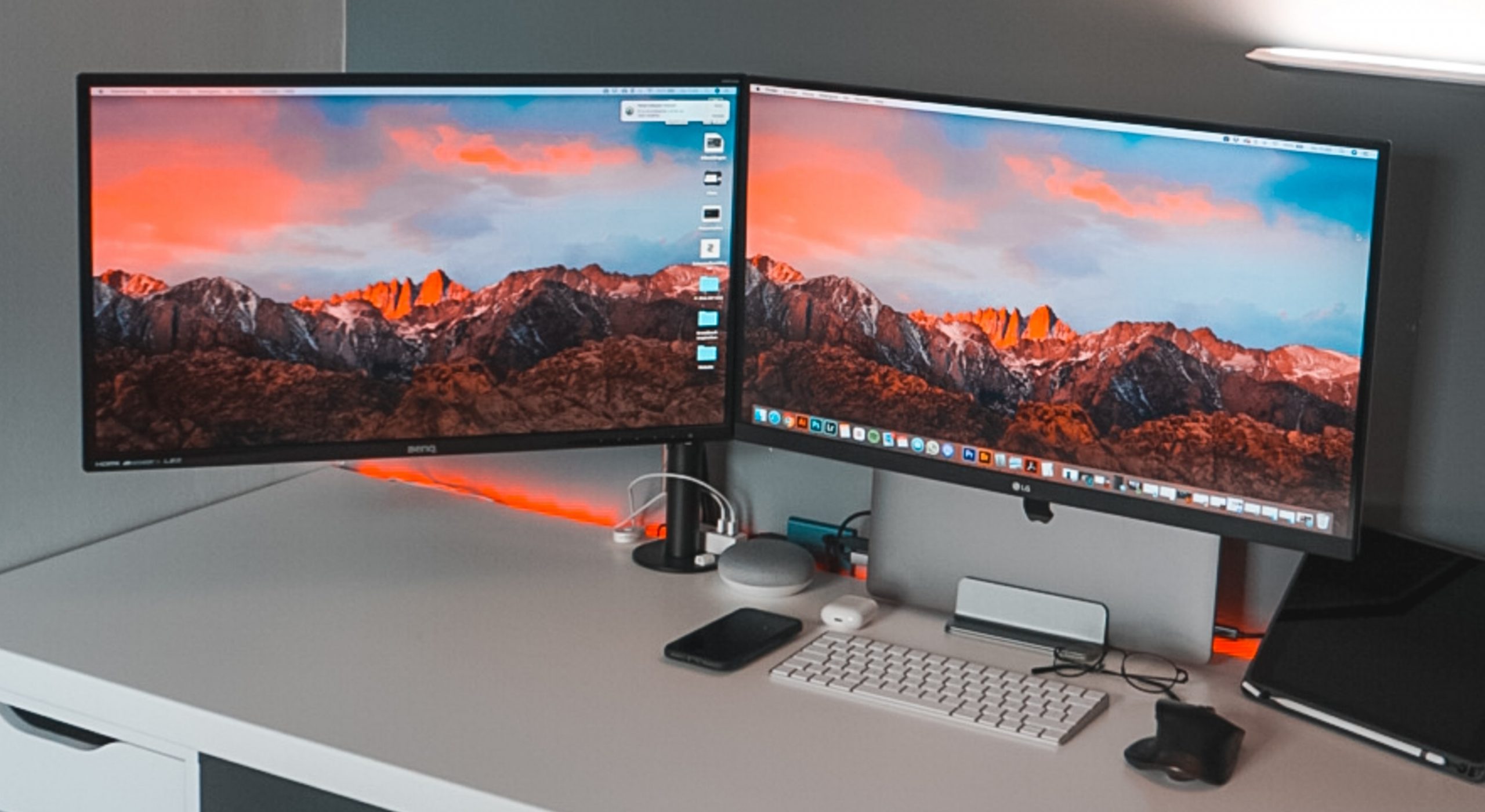 two monitors on white desk