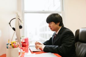 /a-man-using-a-desktop-computer-at-an-office