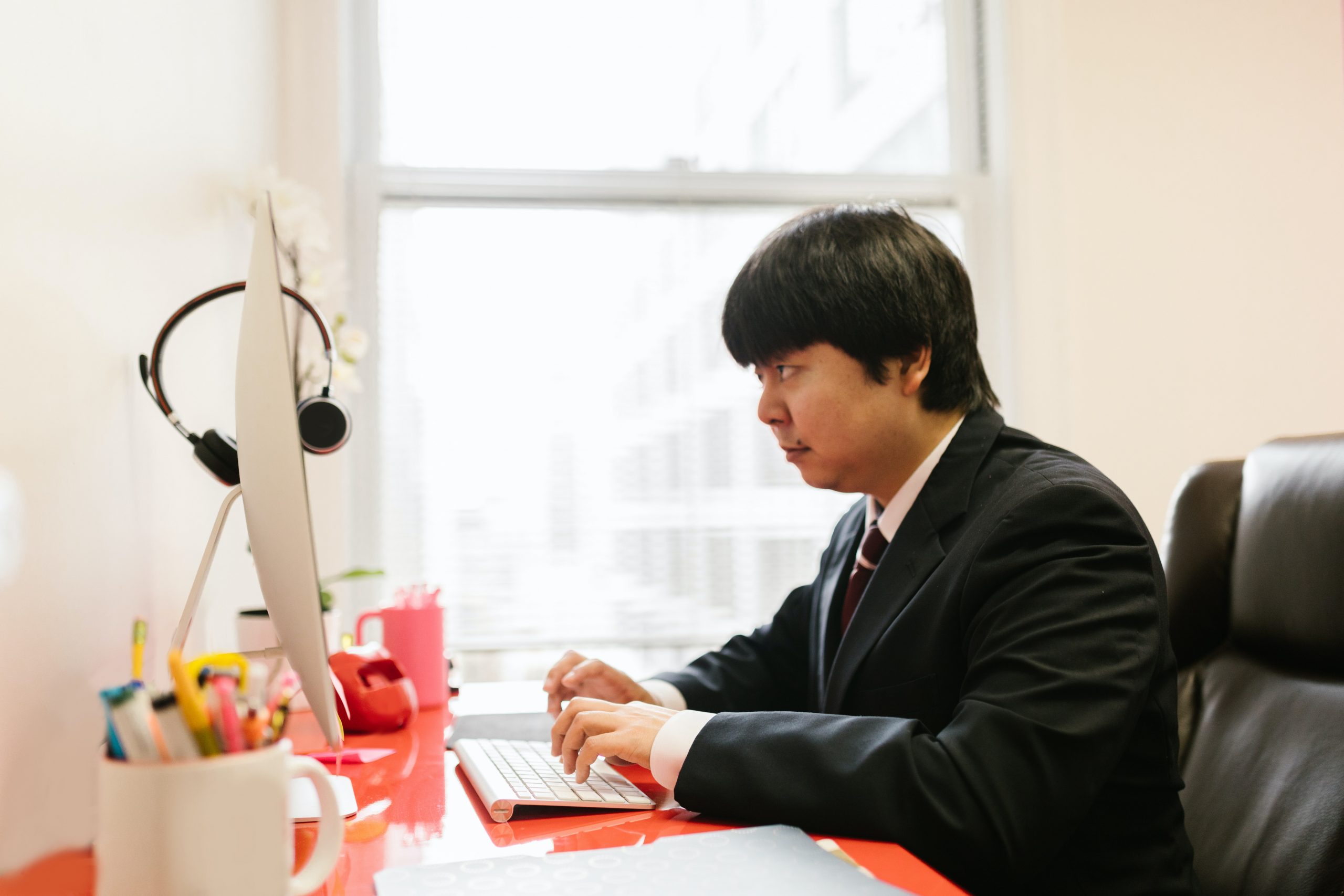 /a-man-using-a-desktop-computer-at-an-office